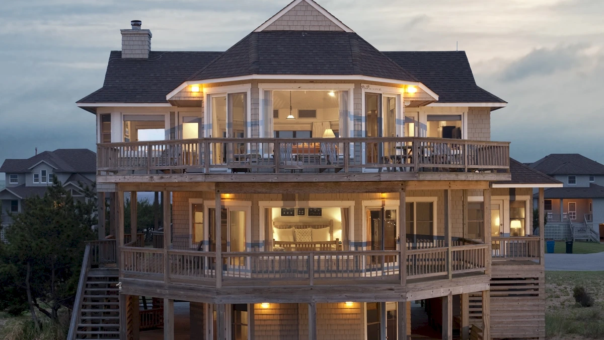 Accommodations 21 Front aerial view of Caffey House 6 Bedroom Residence at sunset.