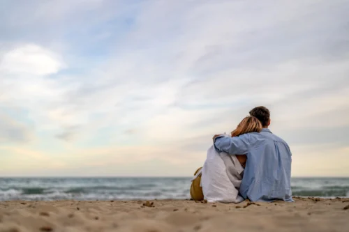 Offers 5 Couple on the beach watching the waves, part of The Sanderling Romance Retreat offer.