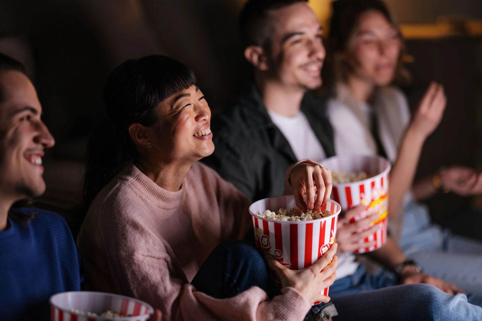 A cozy movie night at the Beach House Loft, where a group of friends enjoys a film together.